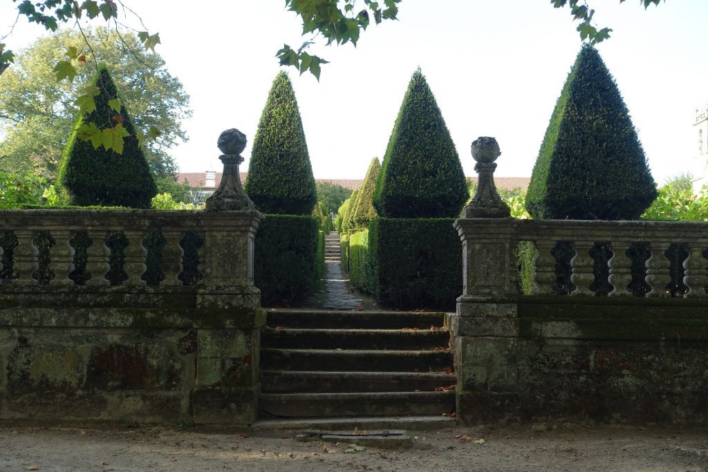 Topiary and stone fence